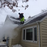 Rooftop ice dam steaming, Our ice dam removal company removing ice from a roof
