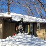 Removing snow from a roof.