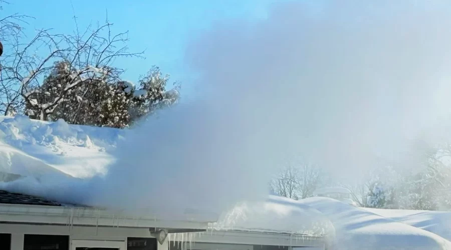 Clearing ice dam with steam.