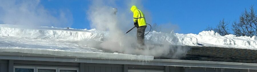 Removing ice dam to stop roof leaking.