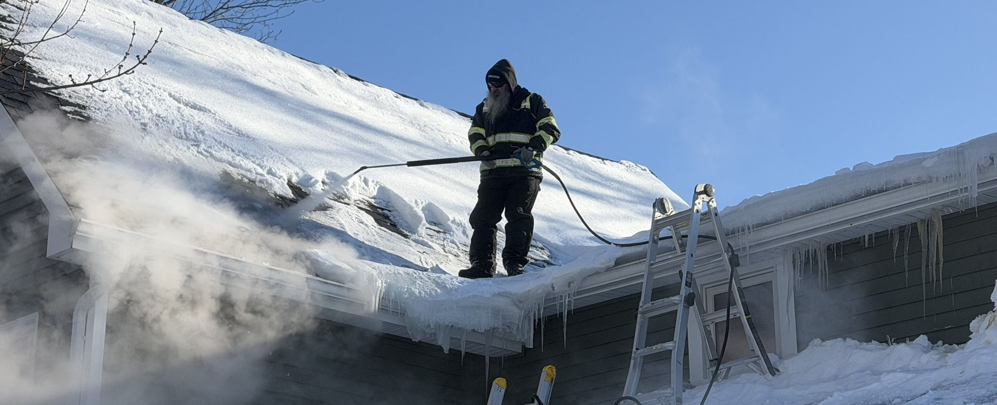 Removing ice dam with steam from roof near Buffalo, NY.
